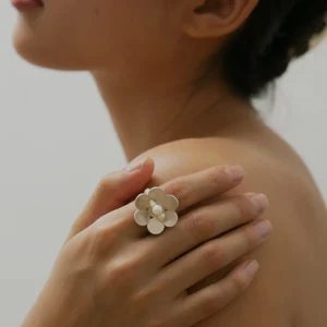 Close-up of a hand wearing the Little Flower Beaded Ring in S925 sterling silver, featuring a delicate floral motif with natural freshwater pearls. Handmade by Lazesoul, this beaded ring captures timeless elegance and organic charm.