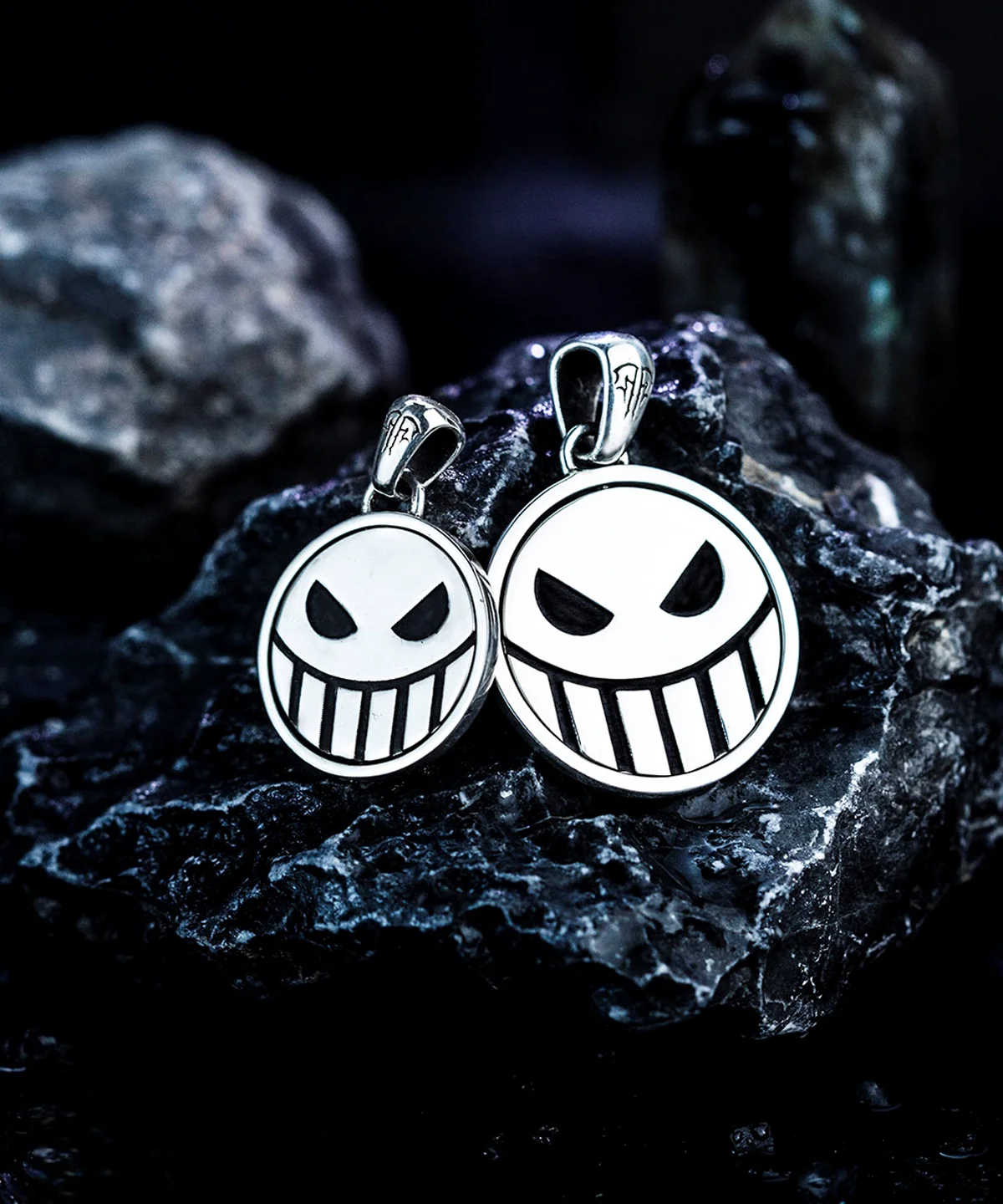 Two S925 silver pirate necklaces feature reversible laugh and cry face spinner pendants, handmade by Lazesoul. Displayed on dark stones, ideal for anime and One Piece fans seeking unique pirate-inspired jewelry.