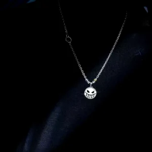 A handcrafted S925 silver pirate necklace with a reversible laugh and cry face spinner pendant inspired by anime. The detailed pendant swings freely on a sleek chain, highlighting One Piece aesthetics and artisan design. Perfect gift for anime fans.