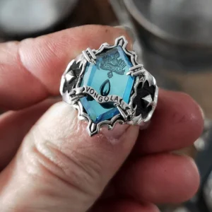 Hand holding Lazesoul’s handmade S925 sterling silver Guardian Ring, Rain Ring design, inspired by Katekyo Hitman Reborn. Features intricate silver details and Vongola inscription with a vibrant blue gemstone.