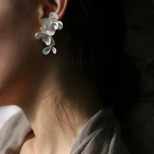 Close-up of model wearing Lazesoul S925 Sterling Silver Filigree Blossom Earrings—delicate floral ear cuff paired with a drop earring, handmade in natural style to embody the elegance of blossom-inspired jewelry.