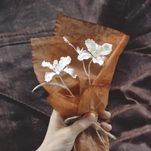 A delicate handmade Iris Bouquet wrapped in rustic brown paper, symbolizing timeless beauty. Perfect as 925 sterling silver Art Gifts from Lazesoul, crafted for meaningful moments and elegant keepsakes.