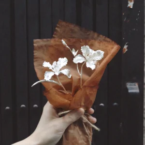A delicate handmade Iris Bouquet wrapped in rustic brown paper, symbolizing timeless elegance. Perfect as 925 sterling silver inspired Art Gifts by Lazesoul, blending artistry with nature‑inspired charm.