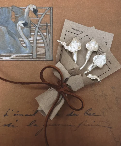 Handmade 925 sterling silver mini Calla Lily Bouquet wrapped in rustic brown paper with suede cord, styled with vintage swan art background. Unique Lazesoul Art Gifts for nature lovers, perfect for timeless, elegant gifting.