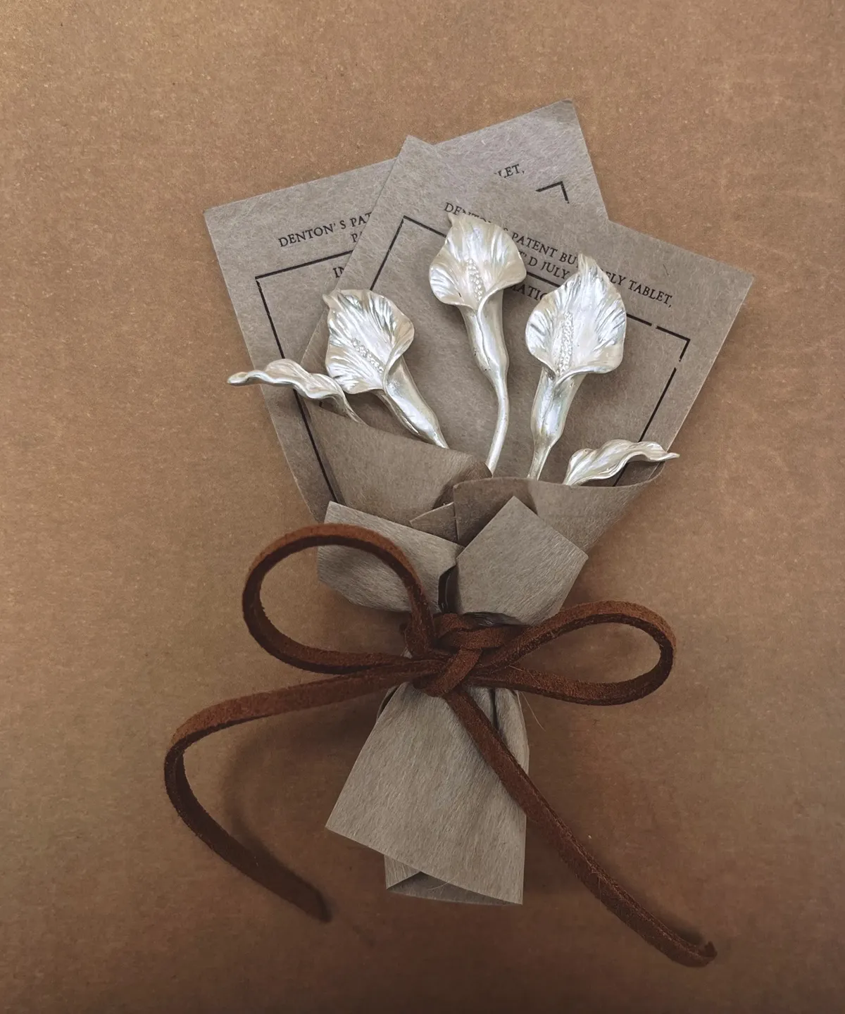 Handmade 925 sterling silver mini Calla Lily Bouquet by Lazesoul, wrapped in vintage brown paper with velvet ribbon. Elegant art gift for home décor, anniversaries, or special occasions. Perfect collectible for Calla Lily Bouquet lovers.