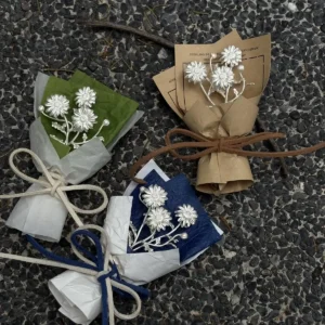 Handcrafted mini daisy bouquet art gift featuring delicate white flowers wrapped in brown, green, and blue paper. Perfect for gifting or décor, this Lazesoul 925 sterling silver inspired Daisy Bouquet adds artisanal charm to any space.