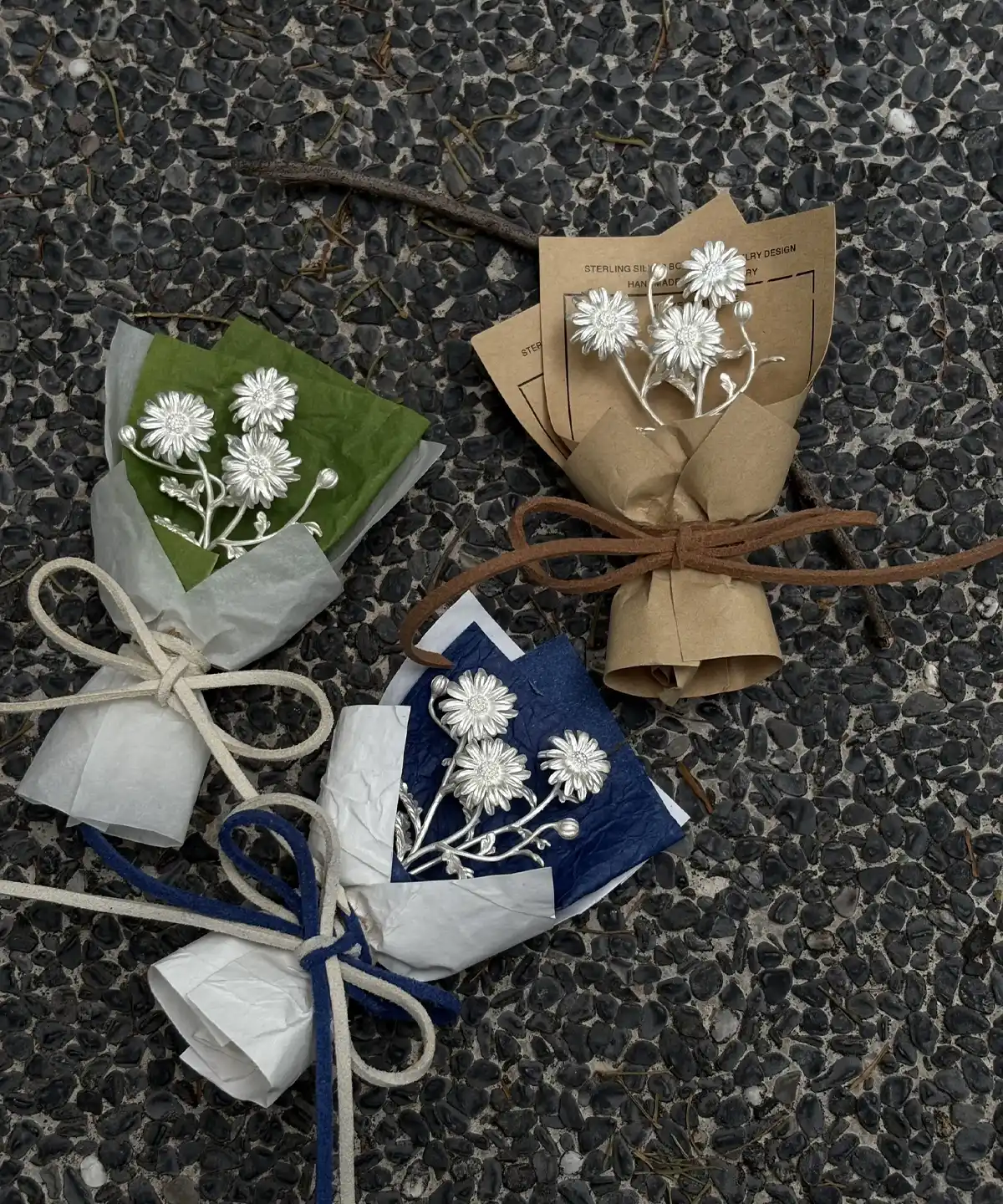Handcrafted mini daisy bouquet art gift featuring delicate white flowers wrapped in brown, green, and blue paper. Perfect for gifting or décor, this Lazesoul 925 sterling silver inspired Daisy Bouquet adds artisanal charm to any space.