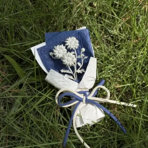Handmade mini Daisy Bouquet art gift with delicate white flowers wrapped in crisp white paper and tied with a blue‑white bow, resting on lush green grass. Lazesoul 925 sterling silver inspired design, perfect for décor, photography, and gifting.