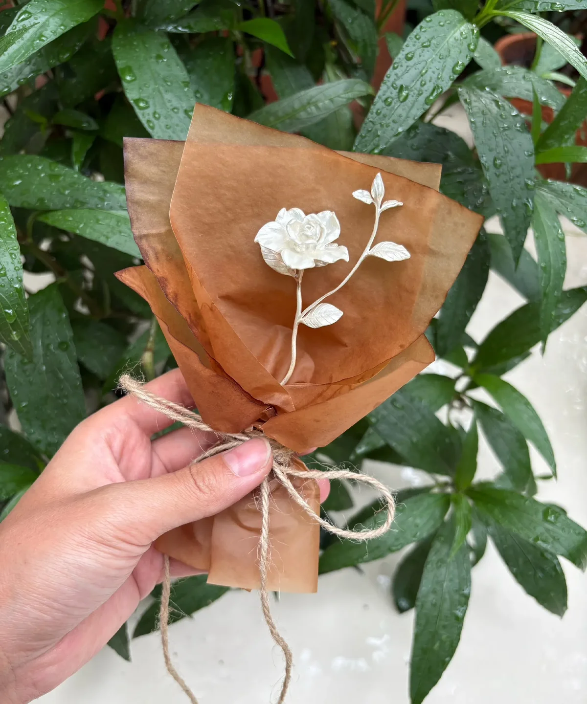 A delicate 925 sterling silver mini Gardenia Bouquet wrapped in rustic brown paper with twine, handmade by Lazesoul. Perfect as timeless Art Gifts, blending nature-inspired elegance with artisanal craftsmanship.