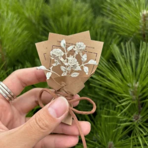 A delicate 925 sterling silver mini rose bouquet, handmade with artistic detail, wrapped in rustic brown paper with a bow. Perfect as unique art gifts, blending timeless elegance with nature-inspired charm from Lazesoul.