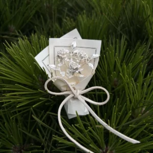 Elegant 925 sterling silver mini rose bouquet on a white card with bow, set against pine needles. Handmade art gift by Lazesoul, perfect for collectors and nature lovers seeking unique rose bouquet jewelry and timeless art gifts.