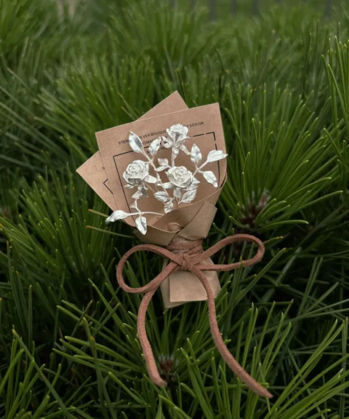 A handcrafted 925 sterling silver mini rose bouquet from Lazesoul, wrapped in brown paper with white floral art, perfect as elegant handmade art gifts for nature lovers and timeless keepsakes.