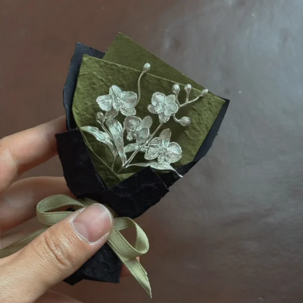 925 Sterling Silver Phalaenopsis Mini Bouquet-Handmade Art Gift 04 Handcrafted 925 sterling silver Phalaenopsis mini bouquet wrapped in black and olive paper with beige ribbon. Elegant handmade art gift by Lazesoul, perfect for unique floral-inspired jewelry and collectible art gifts.