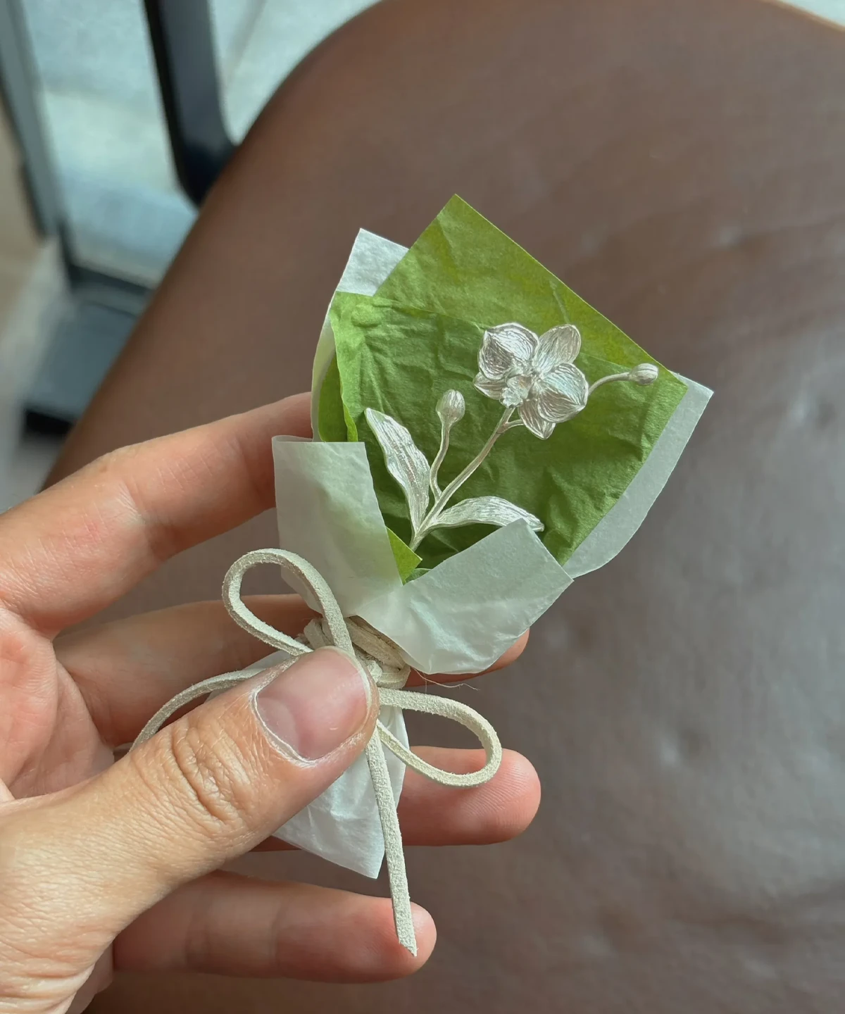 Elegant 925 sterling silver Phalaenopsis mini bouquet wrapped in white and green paper with a beige bow, handmade by Lazesoul. Perfect for unique art gifts, combining fine craftsmanship and timeless floral beauty.