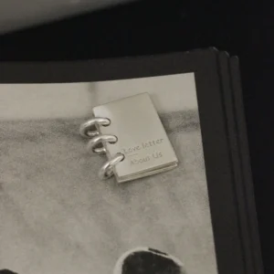 Lazesoul handmade 925 sterling silver book necklace featuring a miniature notebook‑style pendant engraved “Love Letter About Us,” with three binder rings, crafted as personalized custom jewelry for romantic keepsakes and meaningful gifts.
