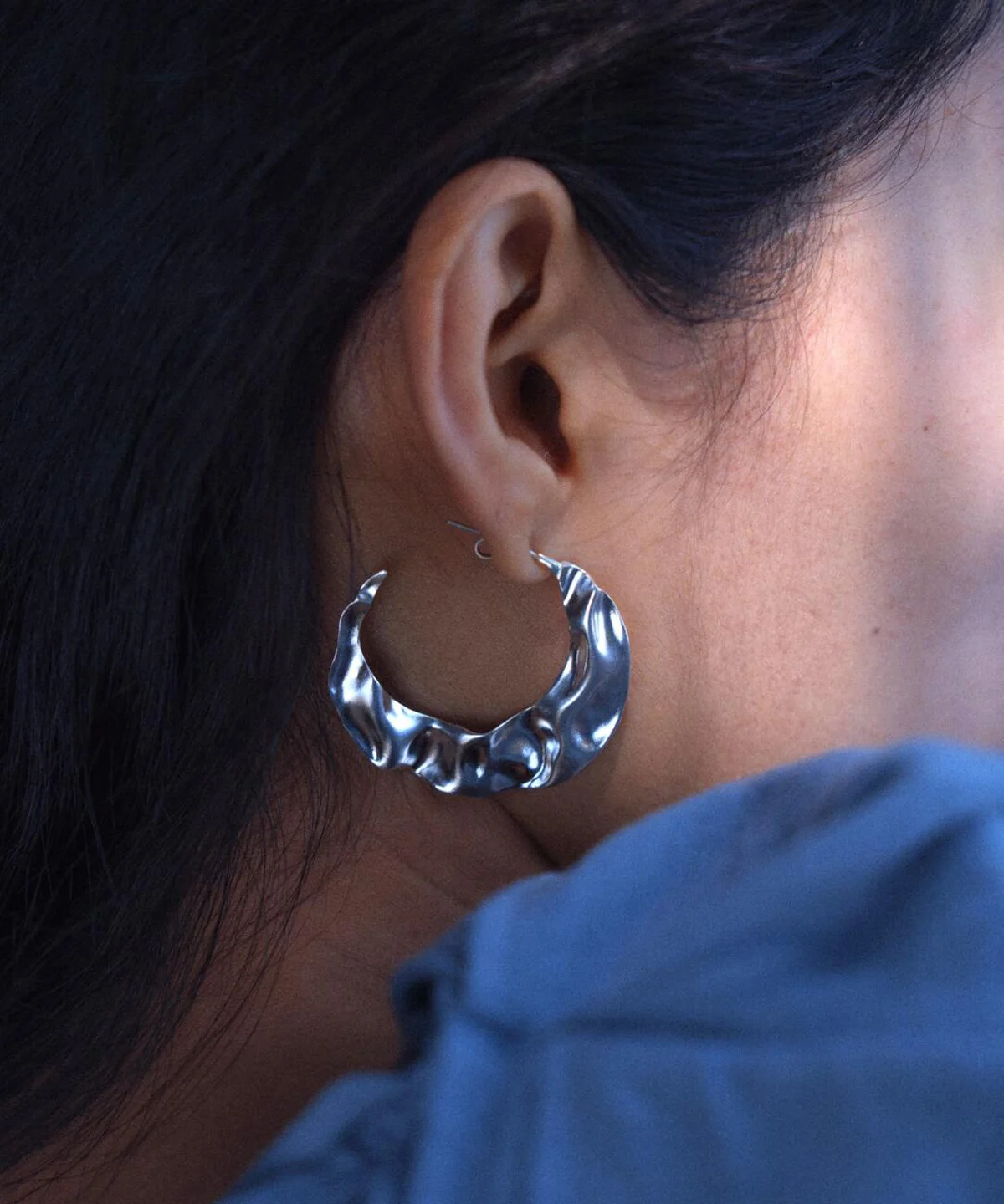 Close-up of Lazesoul’s Moon Aria-990 Pure Silver Sculptural Moon Earrings, featuring a bold wavy hoop design in pure silver. Handmade art jewelry that blends modern elegance with celestial inspiration. Perfect statement Moon Earrings.