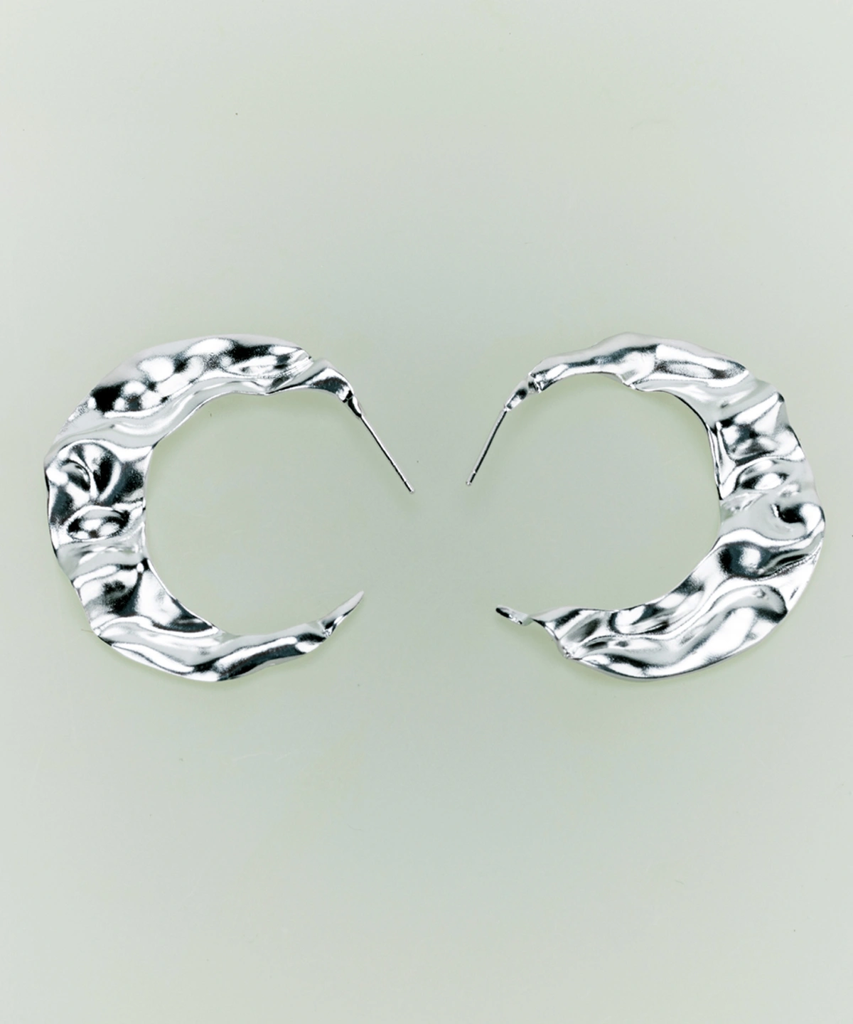 Handcrafted Moon Aria 990 pure silver sculptural moon earrings by Lazesoul, featuring fluid crescent shapes with a textured, wavy surface. Elegant handmade art jewelry for lovers of unique, modern moon earrings.