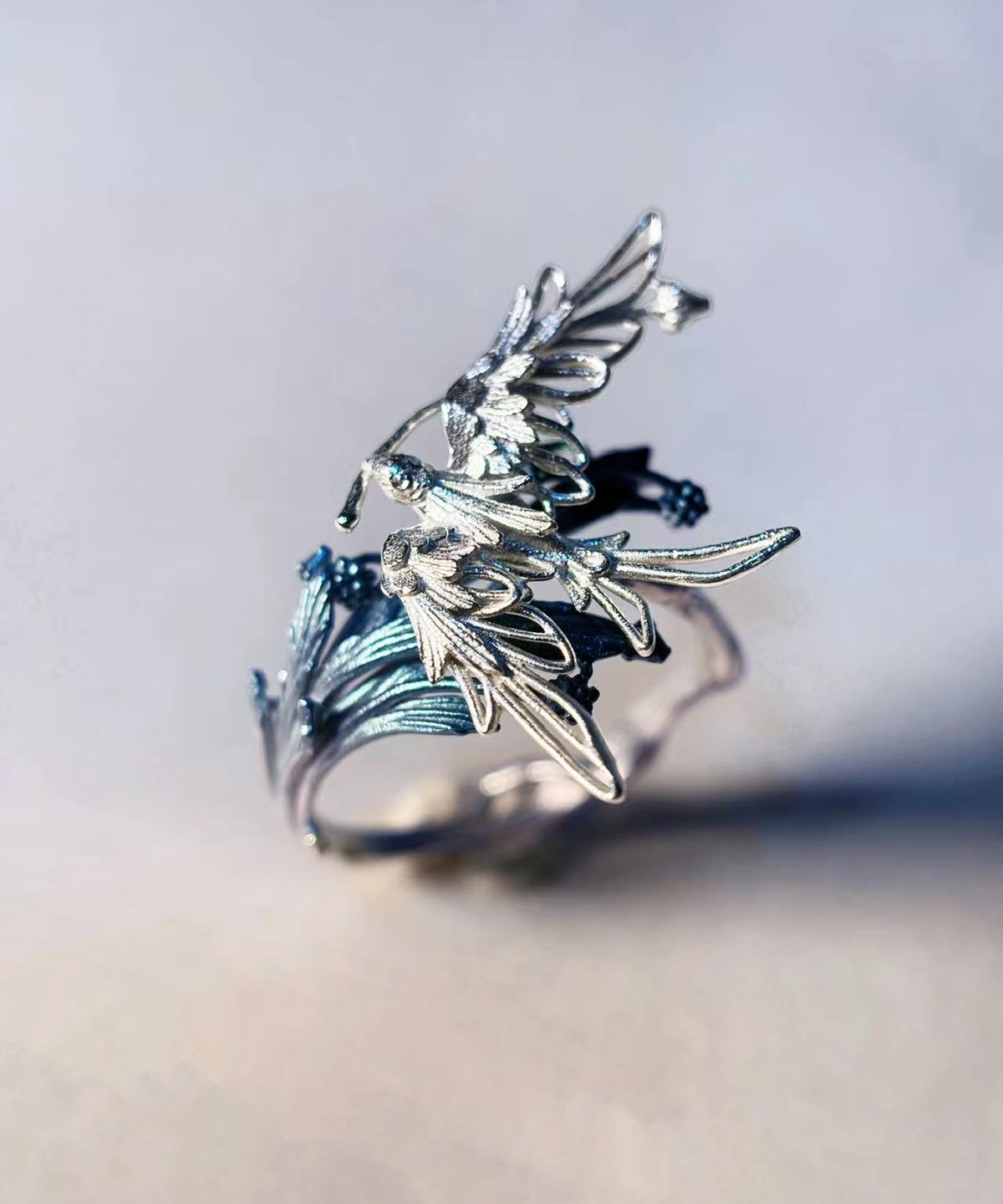 Handmade 925 sterling silver open adjustable statement ring featuring one intricately detailed bird in flight with feathered wings and leaf‑inspired band design, nature‑inspired jewelry by Lazesoul.