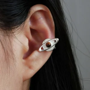 Close-up of ear wearing Lazesoul handmade Saturn Earrings in 925 sterling silver, featuring a polished tiger’s eye gemstone as Saturn with orbit-inspired bands; celestial artisan earrings blending cosmic elegance, astronomy symbolism, and timeless craftsmanship.