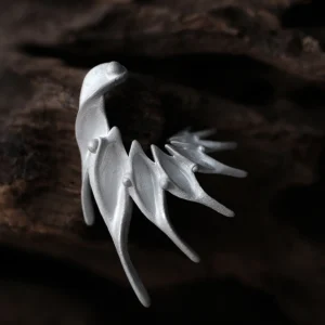 Ethereal Wings designer earrings in S925 sterling silver, handmade by Lazesoul. Abstract, wing‑inspired sculptural forms with flowing lines and pointed tips, displayed on a dark wood background. Elegant artisan jewelry with fantasy and nature aesthetics.