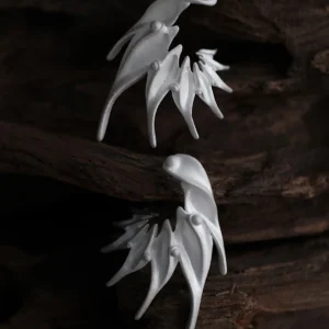 Ethereal Wings designer earrings in S925 sterling silver, handmade by Lazesoul. Sculptural, nature-inspired forms with flowing lines, set against a dark wood background. Elegant artisan jewelry with fantasy and organic aesthetics.