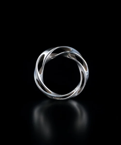 Close-up of Lazesoul Handmade Art Jewelry S925 Sterling Silver Hollow Mobius Strip Ring, featuring an intricate twisted openwork design with interlocking curves and polished surfaces, displayed against a dark background to highlight craftsmanship and elegance.