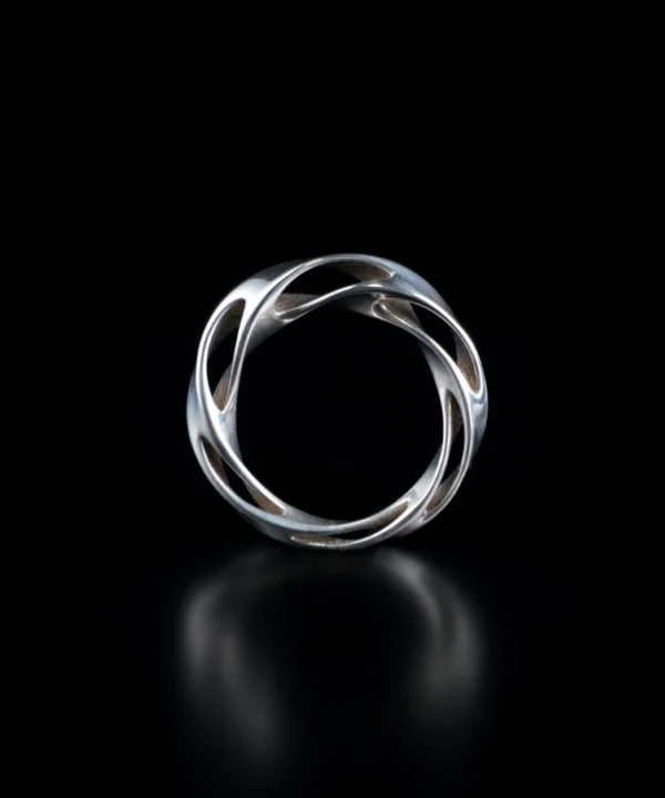 Close-up of Lazesoul Handmade Art Jewelry S925 Sterling Silver Hollow Mobius Strip Ring, featuring an intricate twisted openwork design with interlocking curves and polished surfaces, displayed against a dark background to highlight craftsmanship and elegance.