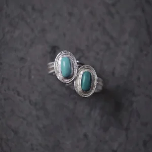 December Birthstone Ring-Natural Turquoise Ring in Sterling Silver 10 Two sterling silver December Birthstone Rings with natural turquoise stones placed on a dark textured surface, showcasing layered bezel settings and handcrafted detail.
