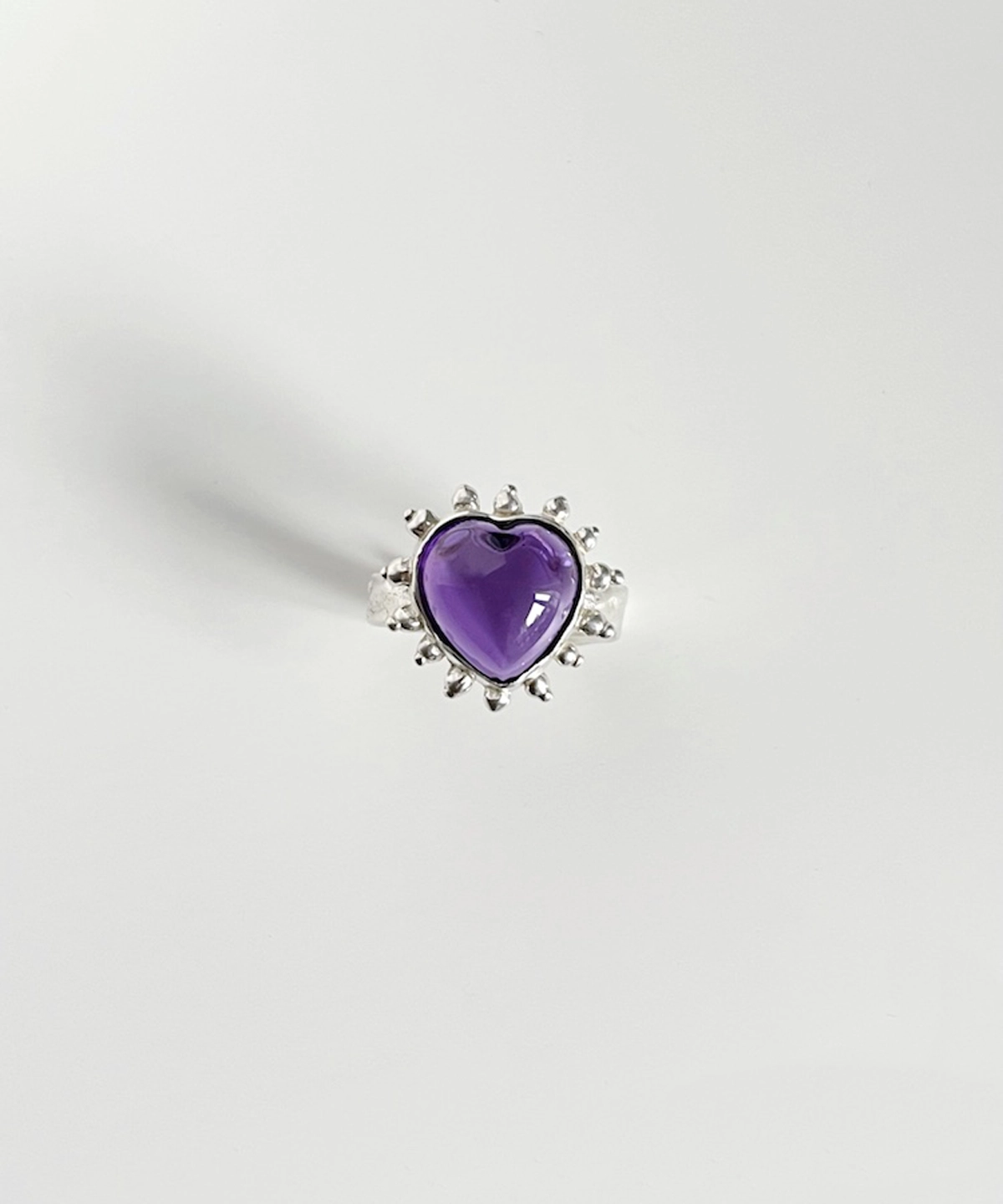 February Birthstone Ring-Natural Amethyst Ring in Sterling Silver 08 Silver ring with heart-shaped natural amethyst gemstone and beaded sunburst detailing, showcasing the February Birthstone Ring in sterling silver on a white surface.