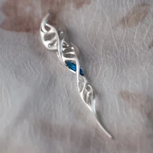 Close-up of Lazesoul Handmade S925 Sterling Silver Spiral Pendant Necklace on fabric background. The spiral pendant features a double helix design in polished silver with a vivid blue gemstone at the center, highlighting the elegant spiral necklace craftsmanship.