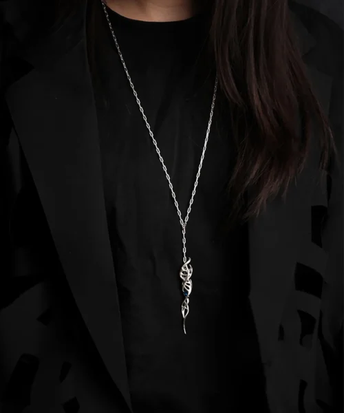 Close-up of Lazesoul Handmade S925 Sterling Silver Spiral Pendant Necklace worn with black shirt and jacket. The spiral pendant features a twisted silver design with a vivid blue gemstone, standing out against dark clothing. Elegant spiral necklace craftsmanship.