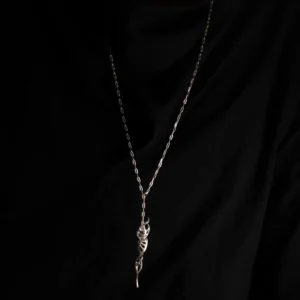 Close-up of Lazesoul Handmade S925 Sterling Silver Spiral Pendant Necklace worn with black clothing. The spiral pendant features a DNA-inspired double helix silver design, hanging centrally on the chest, highlighting the elegant craftsmanship of this spiral necklace.