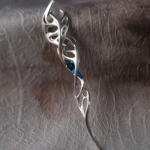 Close-up of Lazesoul Handmade S925 Sterling Silver Spiral Pendant Necklace placed on textured fabric. The spiral pendant features flowing silver curves with vine-like twists and embedded blue gemstones, highlighting the refined artistry of this elegant spiral necklace.