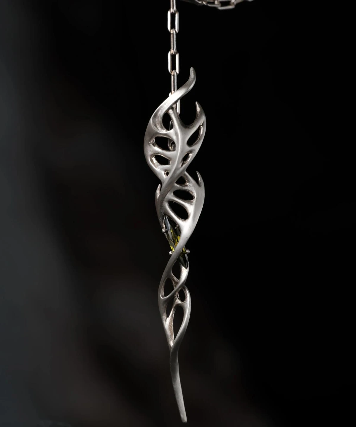 Close-up of Lazesoul Handmade S925 Sterling Silver Spiral Pendant Necklace worn with black clothing. The spiral pendant features a DNA-inspired double helix silver design with polished curves, hanging centrally on the chest. Elegant spiral necklace craftsmanship.