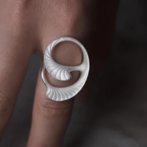Arc Glow S925 Sterling Silver Ring with sculptural curled leaf-inspired design and fine ridged texture; a nature-inspired Unique Ring featuring smooth flowing form, worn on hand and styled against a dark background.
