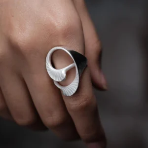 Arc Glow S925 Sterling Silver Ring with sculptural two-tone design, featuring glossy black and matte white curved forms; a nature-inspired Unique Ring with fine ridged textures, worn on hand and styled in close-up view.