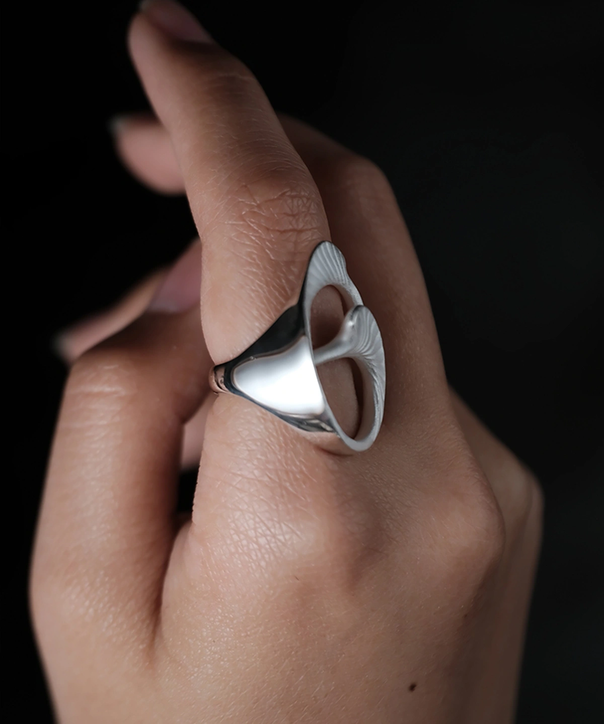 Arc Glow S925 Sterling Silver Ring with sculptural open design and smooth polished surfaces; a nature-inspired Unique Ring featuring organic curves and subtle ridged textures, worn on hand and styled against a dark background.