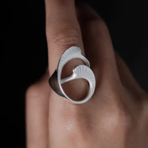 Arc Glow S925 Sterling Silver Ring with sculptural ginkgo leaf-inspired design and polished surface; a nature-inspired Unique Ring featuring curved organic forms and fine textures, worn on hand and styled against a dark background.