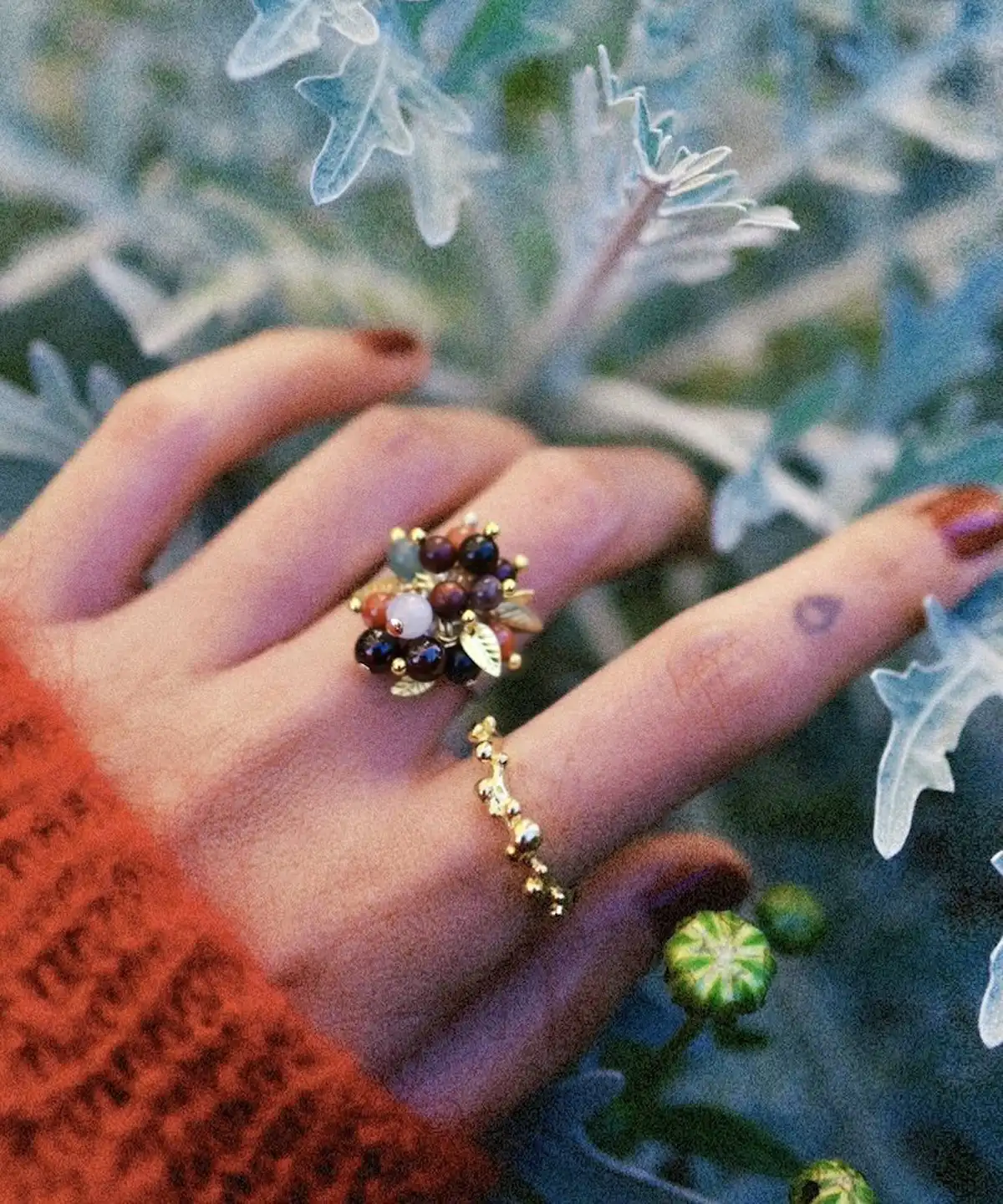925 Sterling Silver Ring with multicolored Natural Stone beads and golden leaf accents, worn on hand with floral gold band; a handcrafted Silver Ring styled against frosty foliage and rust-colored knitwear.