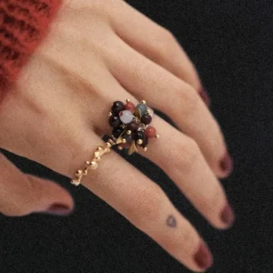 925 Sterling Silver Ring with multicolored Natural Stone beads in red, black, blue, and white, accented with golden leaves and spheres; a handcrafted Silver Ring worn on hand with dark red nails and heart tattoo, styled against dark background.