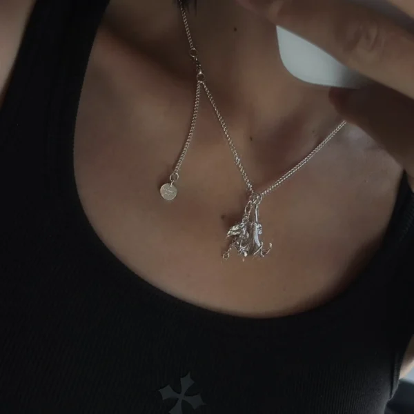 Handmade S925 Silver Necklace featuring a datura flower pendant and custom disc engraved “Balenciaga”; a botanical-inspired Flower Necklace styled on neck with layered silver charms and modern fashion details.