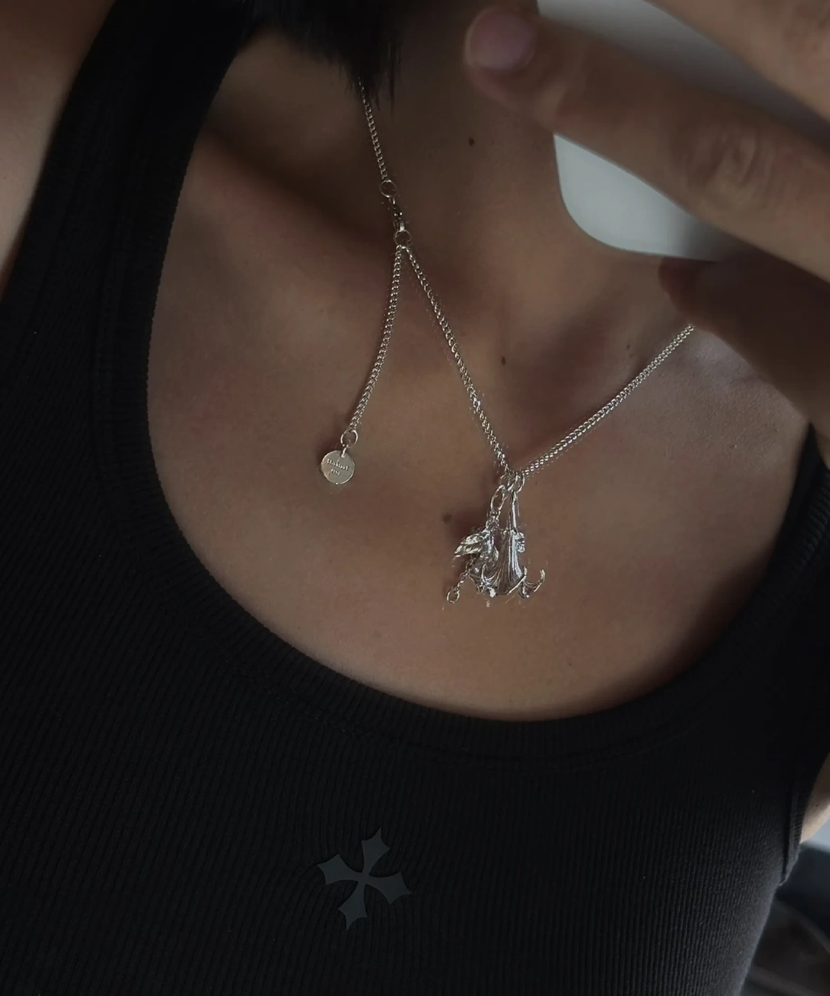 Handmade S925 Silver Necklace featuring a datura flower pendant and custom disc engraved “Balenciaga”; a botanical-inspired Flower Necklace styled on neck with layered silver charms and modern fashion details.