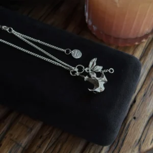 Datura Flower Necklace-Handmade S925 Silver With Custom Disc 06 Handmade S925 Silver Necklace featuring a stylized datura flower pendant with antlers and leaves, displayed on black velvet; includes custom disc charm. A unique Silver Necklace with botanical and fantasy-inspired design.