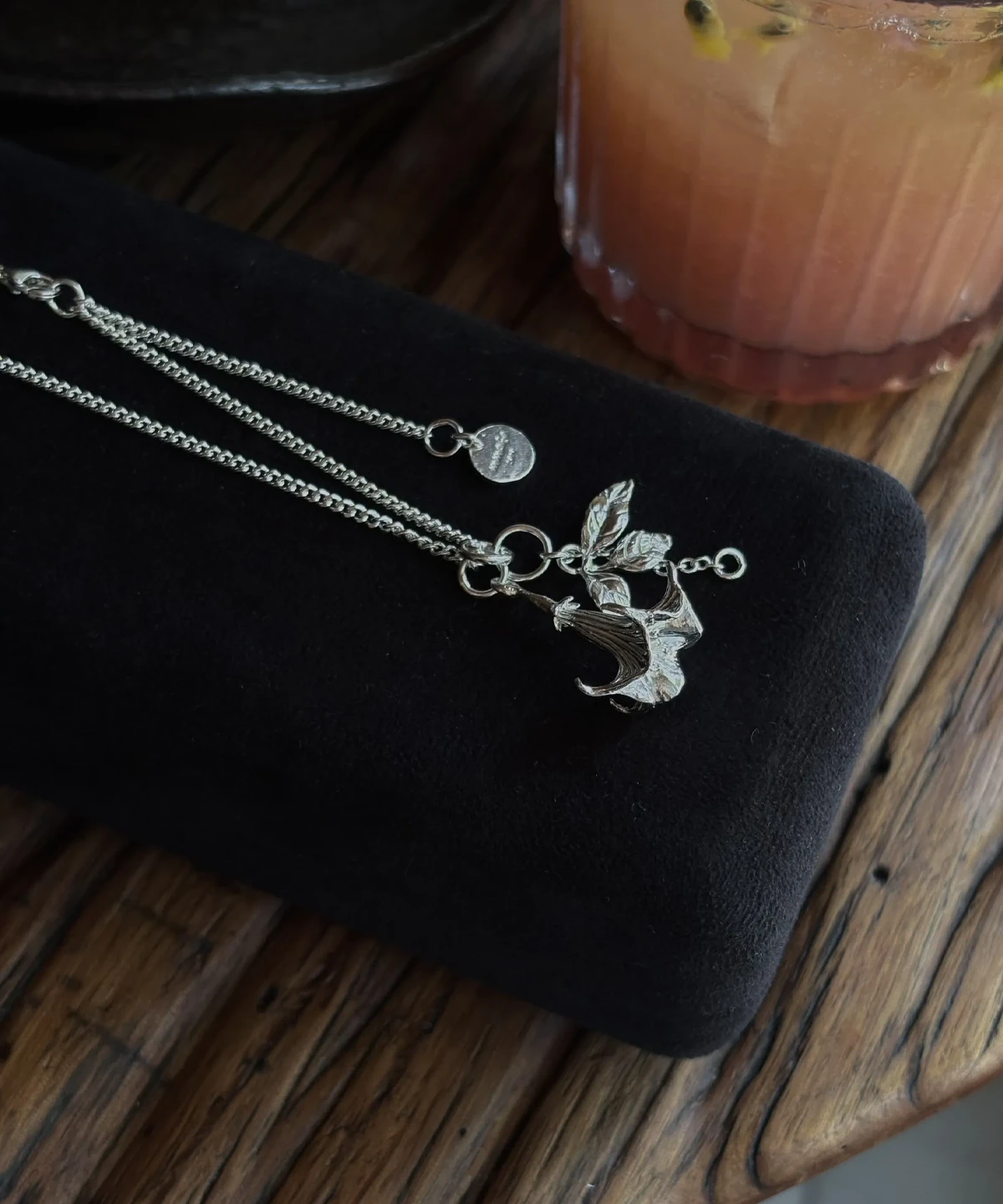 Datura Flower Necklace-Handmade S925 Silver With Custom Disc 06 Handmade S925 Silver Necklace featuring a stylized datura flower pendant with antlers and leaves, displayed on black velvet; includes custom disc charm. A unique Silver Necklace with botanical and fantasy-inspired design.