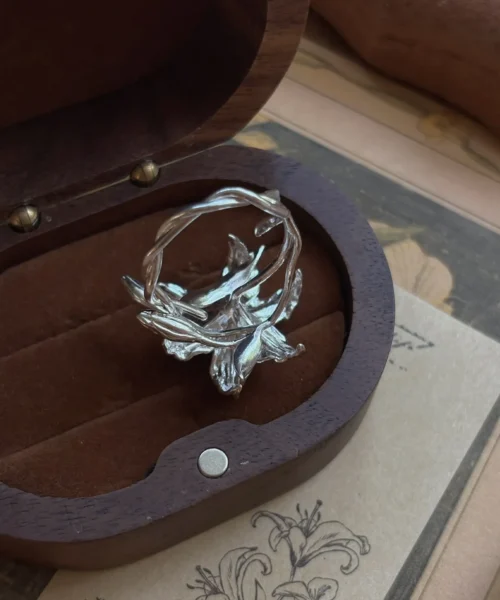 Handmade S925 Sterling Silver Lily Ring with sculpted floral petals and leaves, placed in a velvet-lined wooden box; a botanical Silver Ring inspired by the elegance of the lily flower, showcasing artisanal detail and nature-themed craftsmanship.