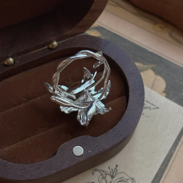 Handmade S925 Sterling Silver Lily Ring 05 Handmade S925 Sterling Silver Lily Ring with sculpted floral petals and leaves, placed in a velvet-lined wooden box; a botanical Silver Ring inspired by the elegance of the lily flower, showcasing artisanal detail and nature-themed craftsmanship.