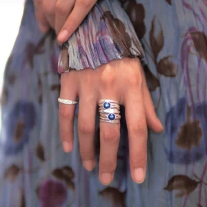 June birthstone ring with two natural black pearls in sterling silver worn with stacked silver rings