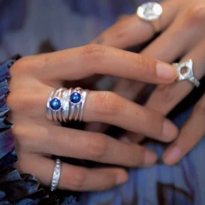 Natural black pearl sterling silver ring worn in a layered silver ring styling look