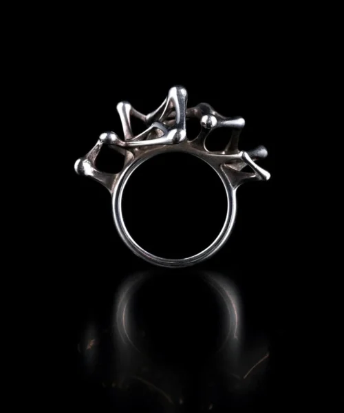 Leaping Orbit Handcrafted 999 Fine Silver Statement Ring with abstract skeletal design, placed against a black background; a sculptural Silver Statement Ring featuring flowing interconnected shapes and polished surfaces.
