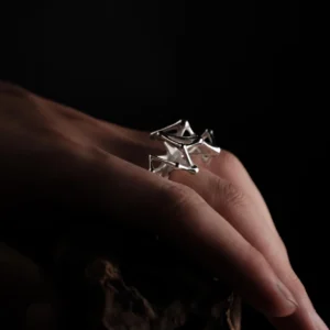 Leaping Orbit Handcrafted 999 Fine Silver Statement Ring with angular geometric design, worn on hand; a sculptural Silver Statement Ring featuring polished interconnected shapes, styled against a textured organic surface.